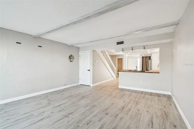 a kitchen with granite countertop kitchen island wooden floor center island and stainless steel appliances