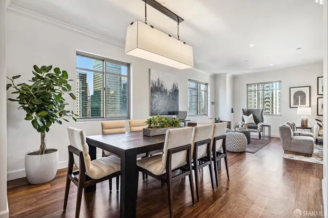a view of a dining room with furniture window and wooden floor