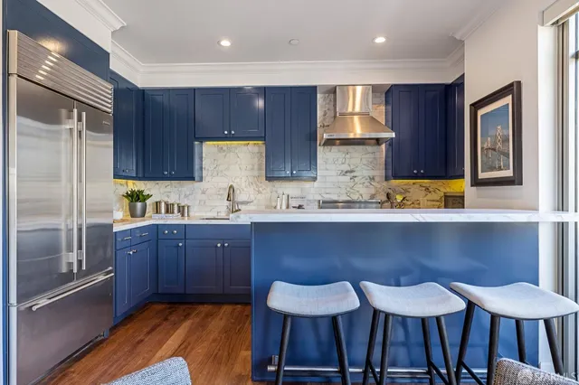 a kitchen with wooden floors and wooden cabinets