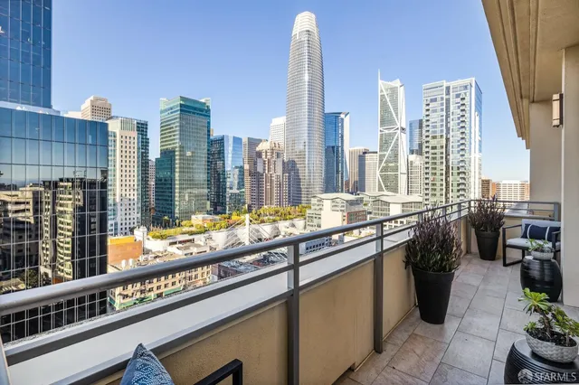 a kitchen with tall windows and a sink