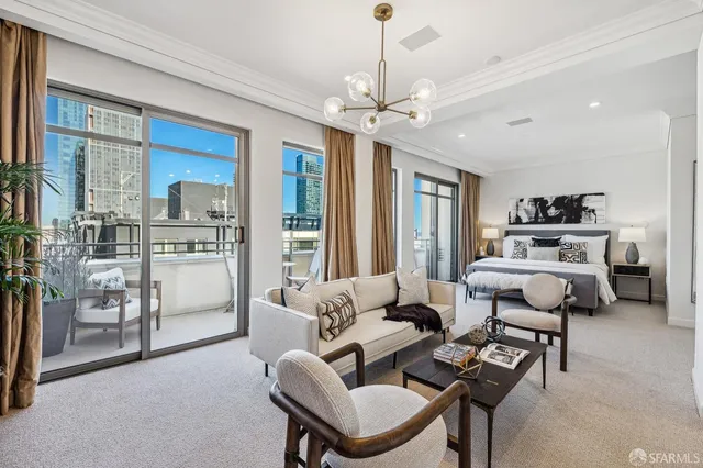 a living room with furniture and a chandelier