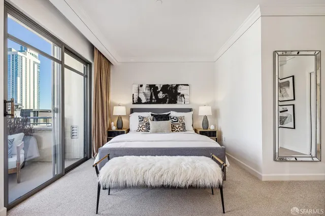 a bedroom with a large bed and a large mirror