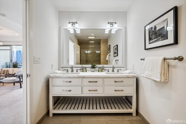 a view of a kitchen from the hallway with a sink and wooden floor