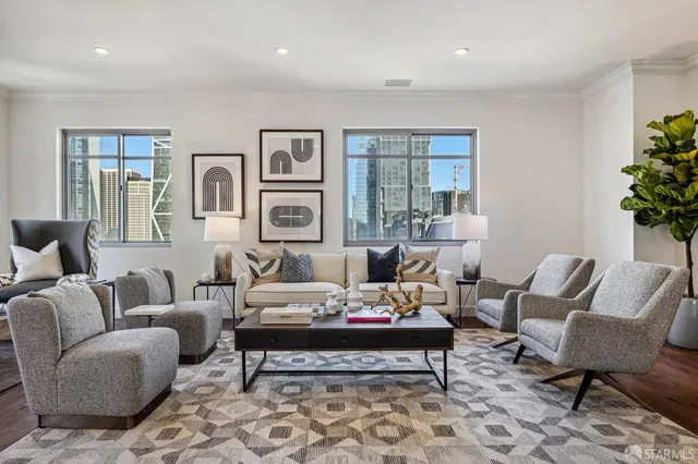 a living room with furniture and wooden floor