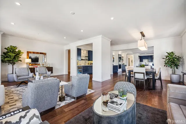 a living room with furniture a dining table and a potted plant