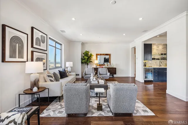 a living room with furniture wooden floor and a large window