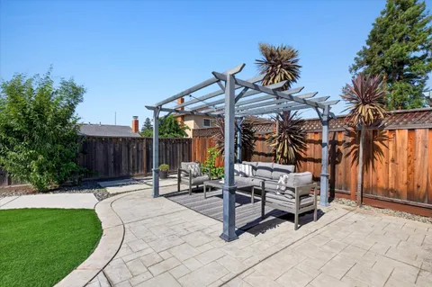 a view of a backyard with sitting area
