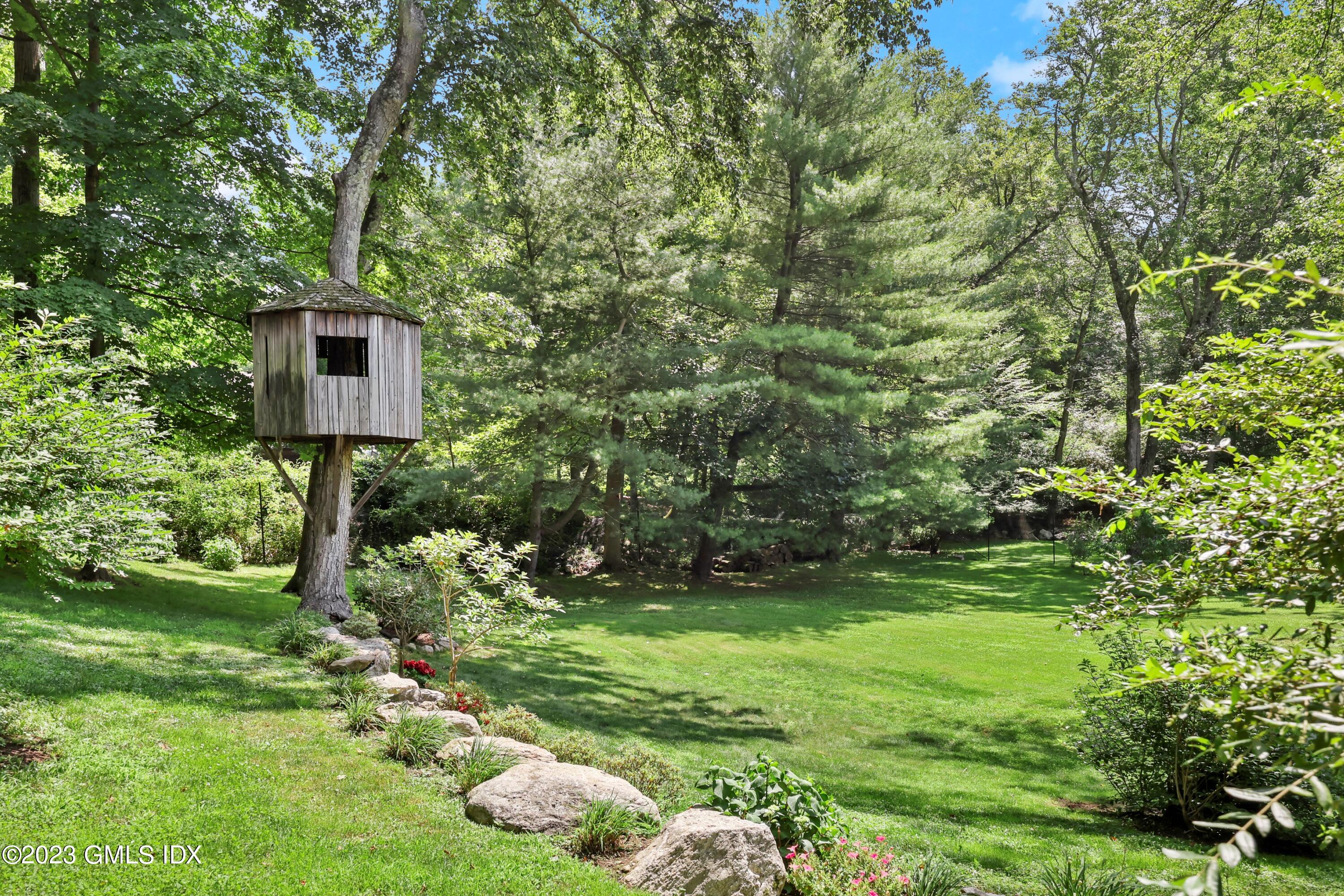 207 Farms Road Stamford, CT 06903 - Photo 11 of 47 a yellow house with lots of trees