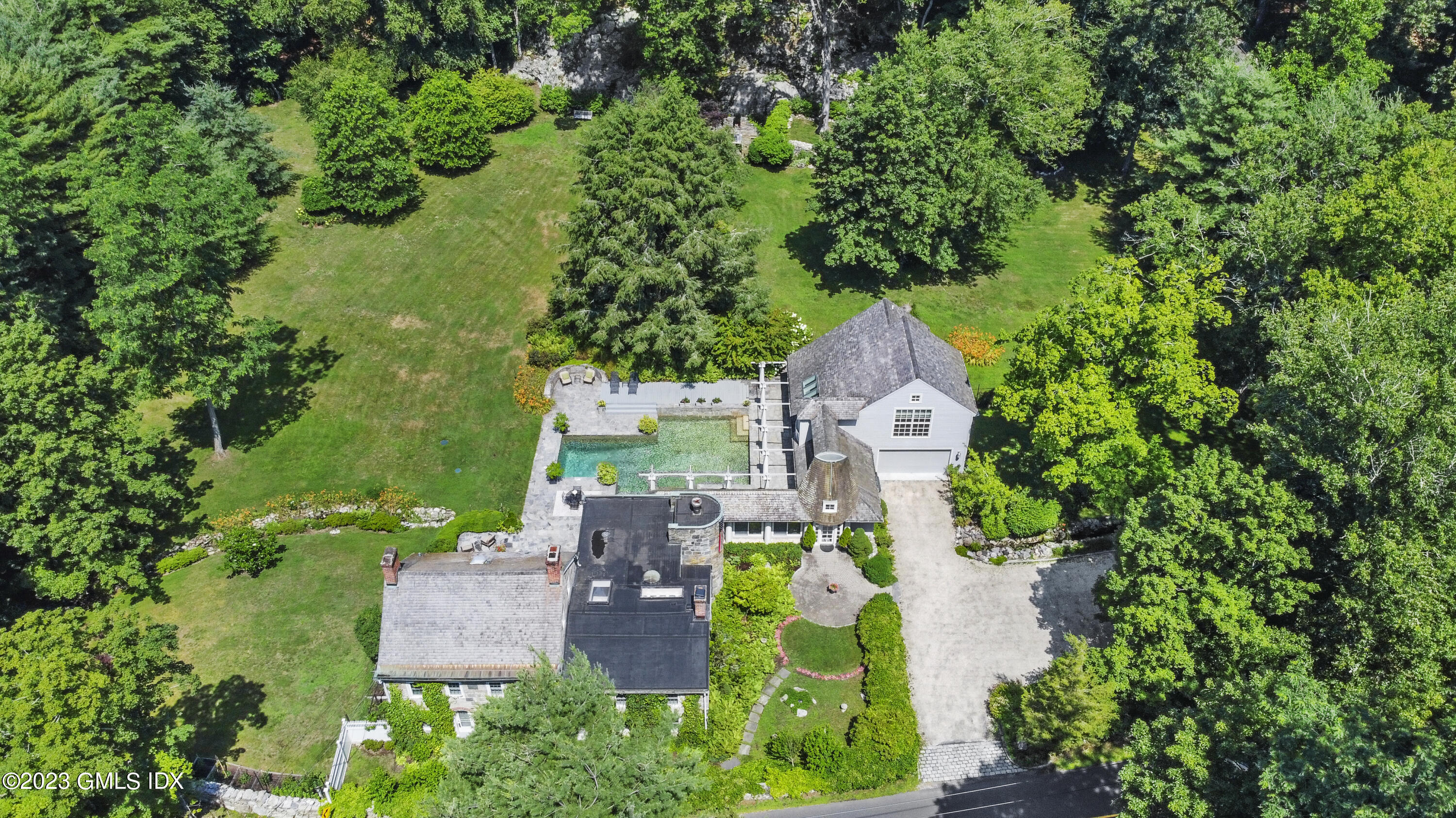 207 Farms Road Stamford, CT 06903 - Photo 14 of 47 an aerial view of a house with garden space and trees all around