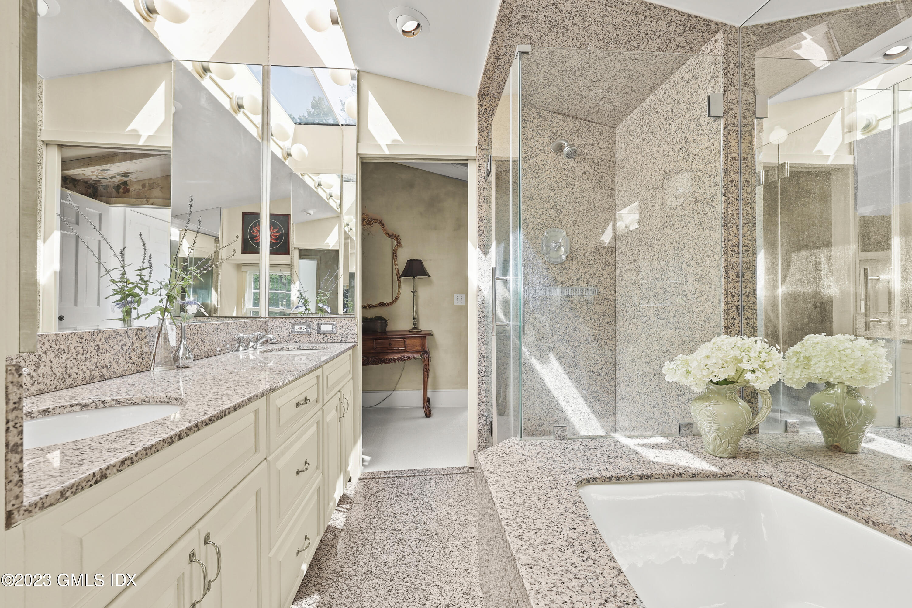 207 Farms Road Stamford, CT 06903 - Photo 27 of 47 a bathroom with a granite countertop sink a mirror and a shower