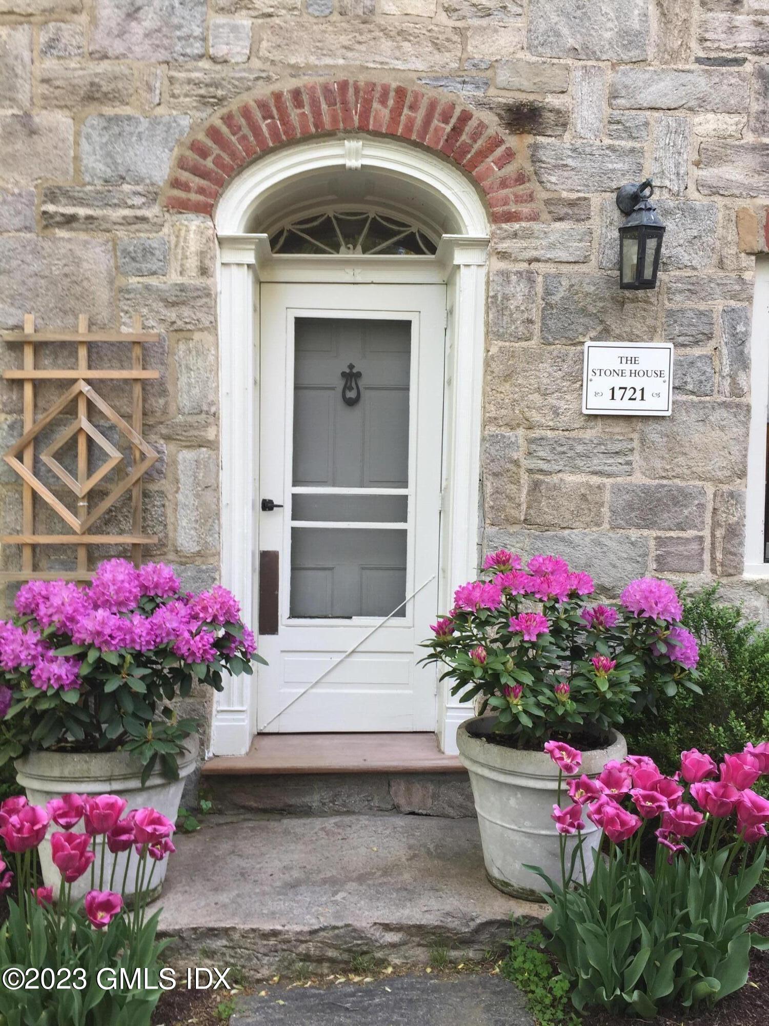 207 Farms Road Stamford, CT 06903 - Photo 3 of 47 a view of front door of house and flowers