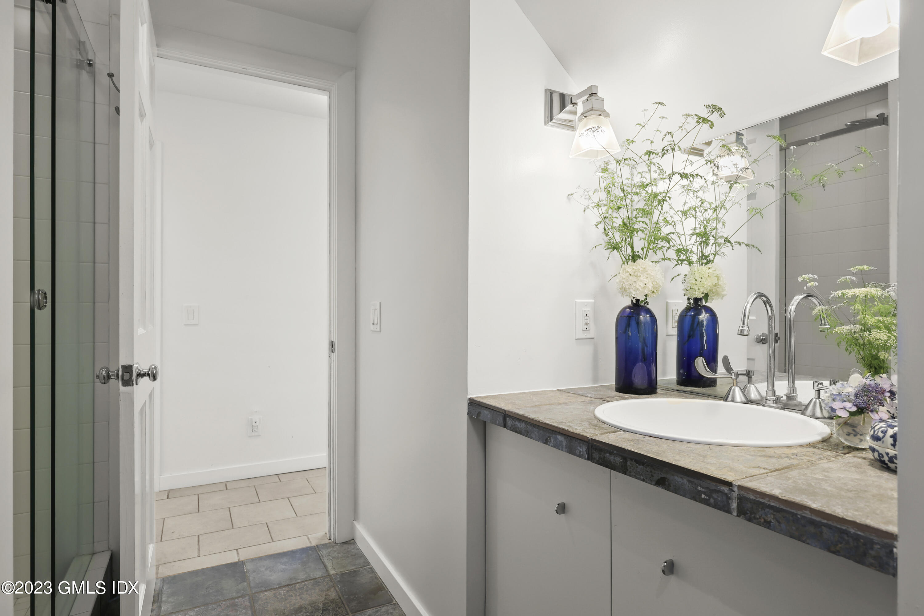 207 Farms Road Stamford, CT 06903 - Photo 35 of 47 a bathroom with a granite countertop sink and a mirror