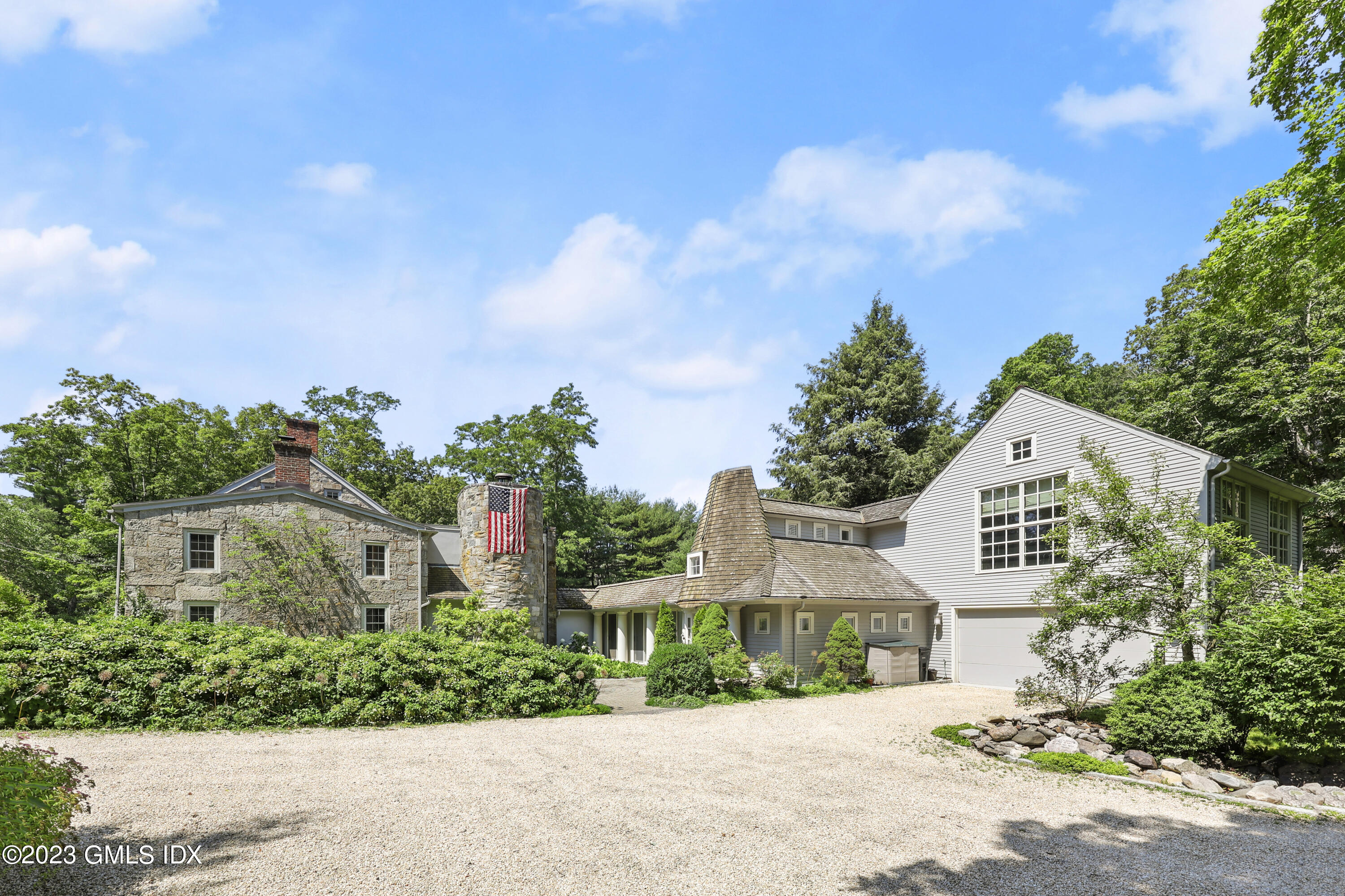 207 Farms Road Stamford, CT 06903 - Photo 4 of 47 a front view of a house with a garden and mountain view