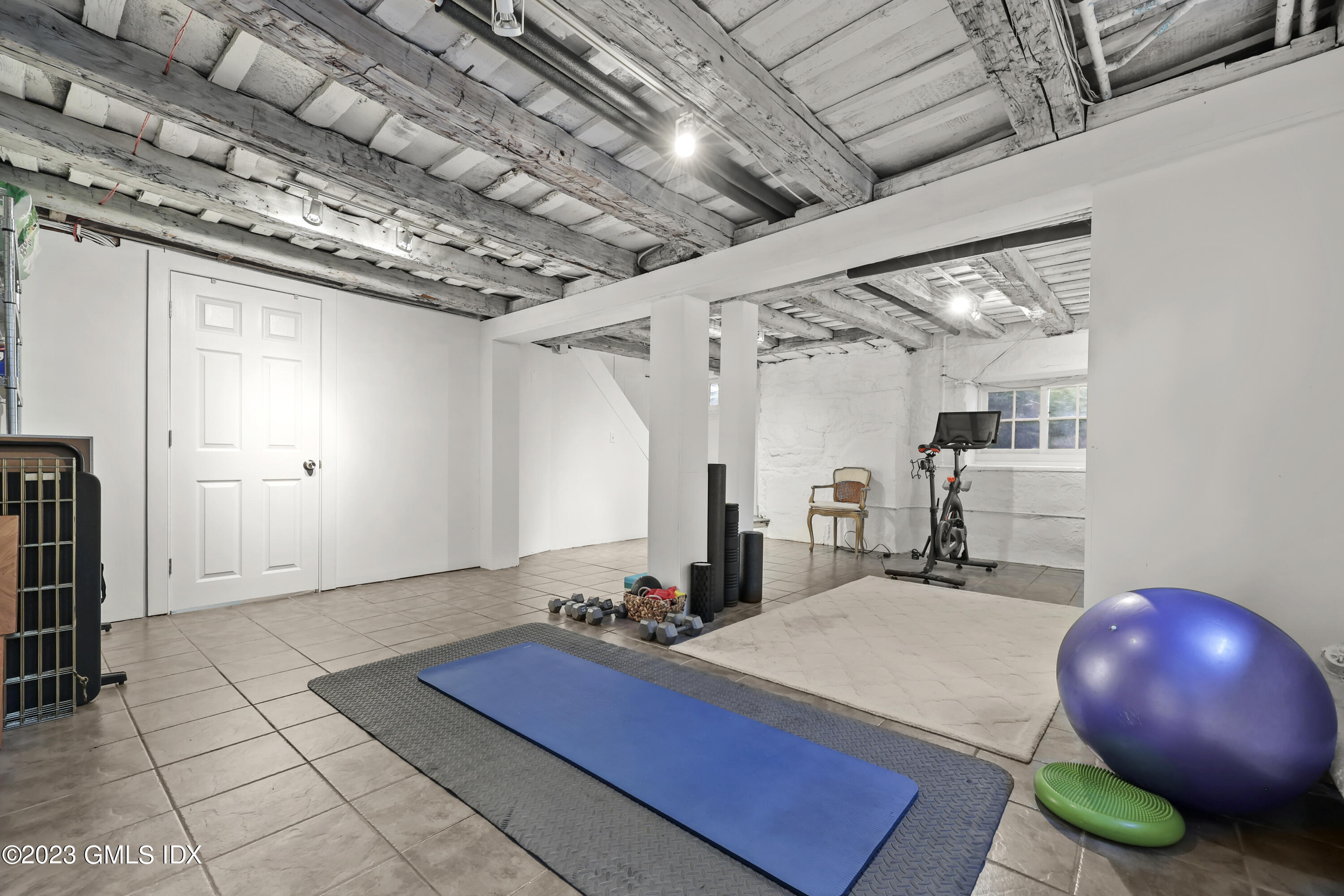 207 Farms Road Stamford, CT 06903 - Photo 43 of 47 a room with gym equipment and wooden floor