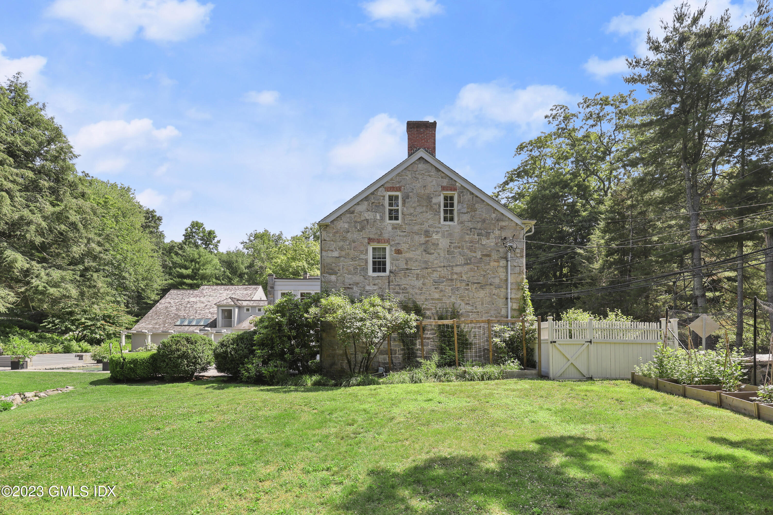 207 Farms Road Stamford, CT 06903 - Photo 8 of 47 a front view of a house with a yard and garage