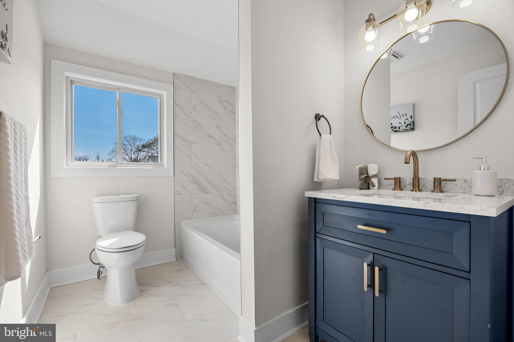 10 Cobblestone Road Cherry Hill, NJ 08003 - Photo 12 of 15 a bathroom with a toilet sink and mirror