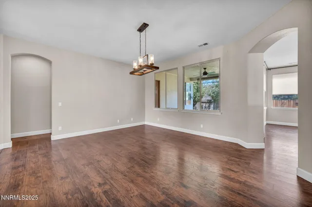 an aerial view of a house with garden space and mountain view in back