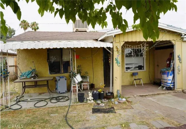 a view of a house with outdoor seating