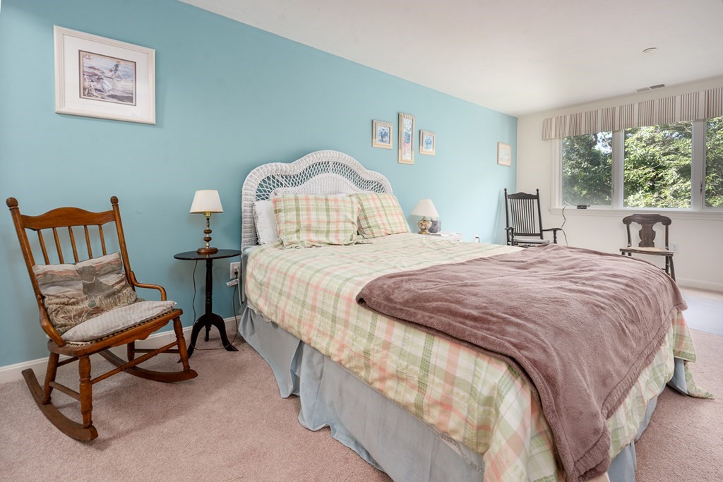 17 North Ridge Road, Unit 444 Mashpee, MA 02649 - Photo 13 of 18 a bedroom with a bed and a chair