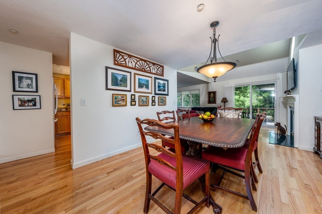 17 North Ridge Road, Unit 444 Mashpee, MA 02649 - Photo 4 of 18 a dining room with a wooden table and chairs