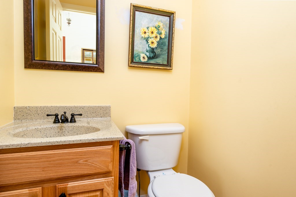 17 North Ridge Road, Unit 444 Mashpee, MA 02649 - Photo 10 of 18 a bathroom with a toilet a sink and mirror