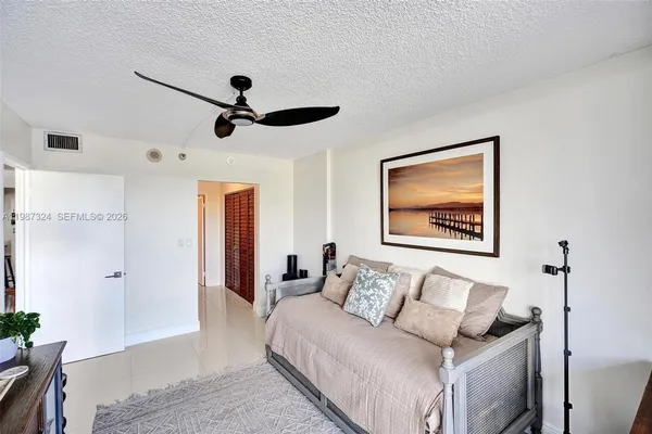 a bedroom with a large bed and a large window