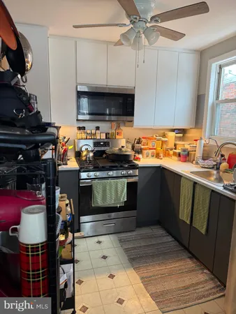 a kitchen with stainless steel appliances a stove and a microwave