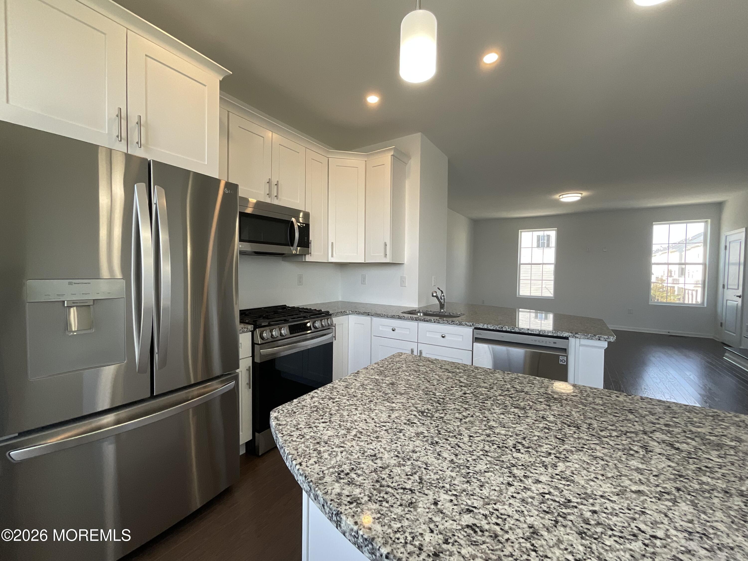 304 Prestige Road, Unit 2404 Brick, NJ 08723 - Photo 2 of 25 a kitchen with granite countertop a refrigerator stove and sink