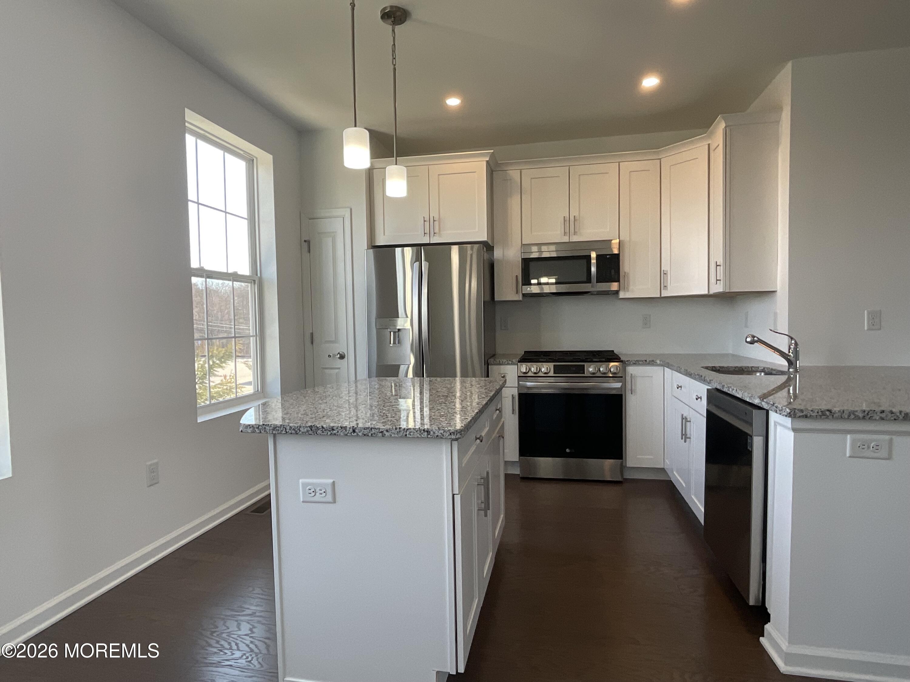 304 Prestige Road, Unit 2404 Brick, NJ 08723 - Photo 4 of 25 a kitchen with stainless steel appliances granite countertop a stove a sink and a refrigerator