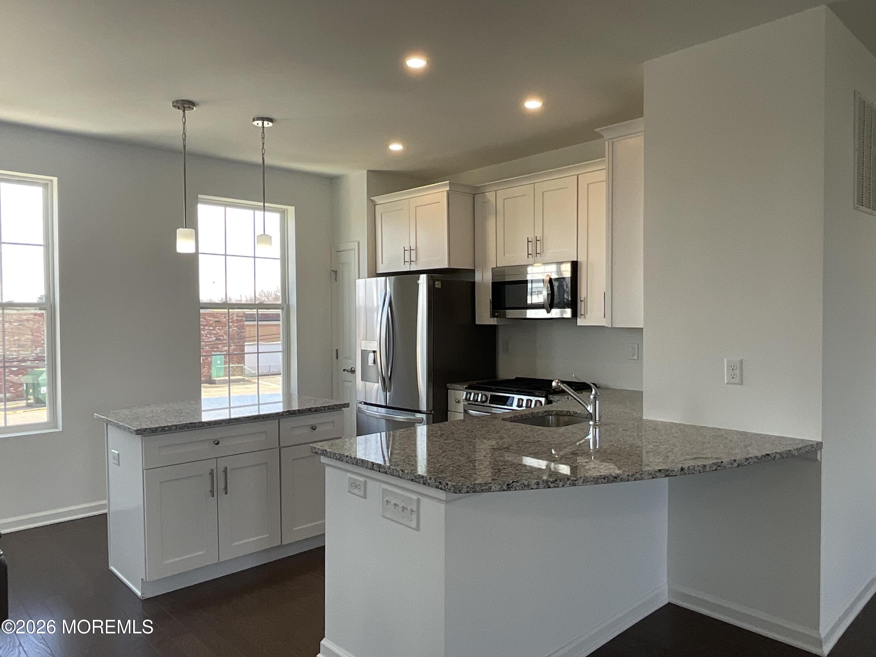 304 Prestige Road, Unit 2404 Brick, NJ 08723 - Photo 7 of 25 a kitchen with counter top space cabinets and appliances
