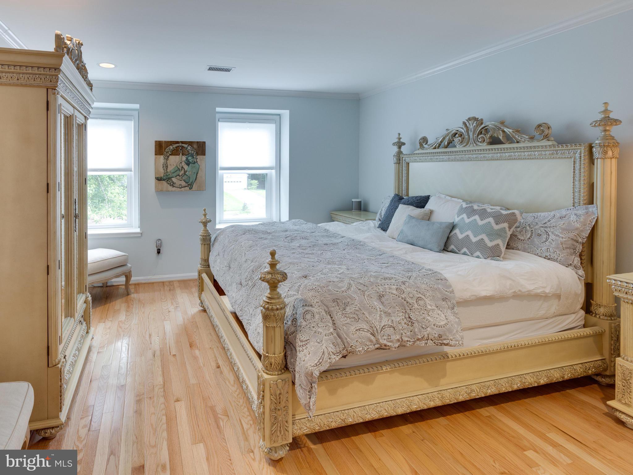 9031 Edgepark Road Vienna, VA 22182 - Photo 12 of 30 a spacious bedroom with a bed and wooden floor