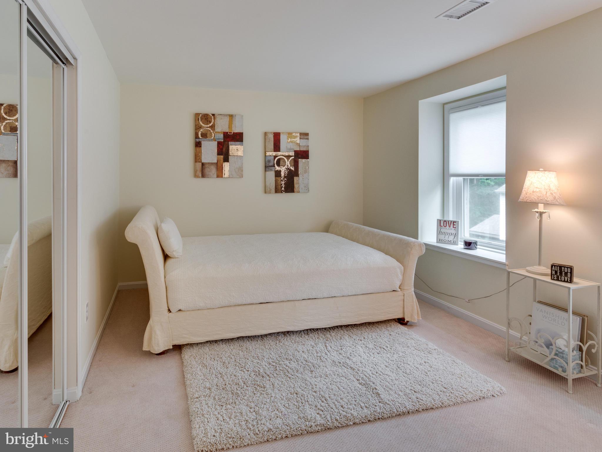 9031 Edgepark Road Vienna, VA 22182 - Photo 17 of 30 a bedroom with a bed and a couch