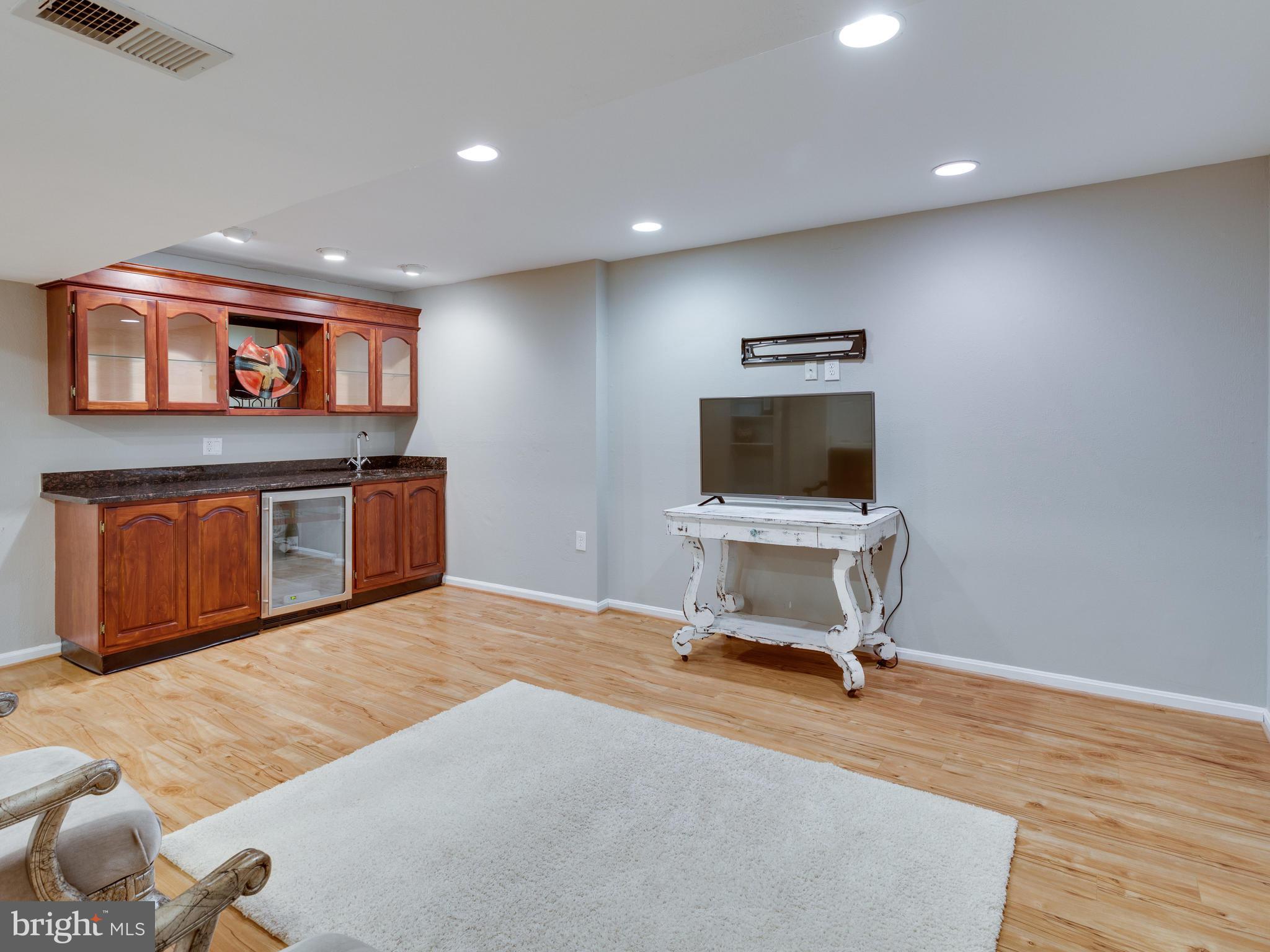 9031 Edgepark Road Vienna, VA 22182 - Photo 21 of 30 a living room with a flat screen tv and gym equipment