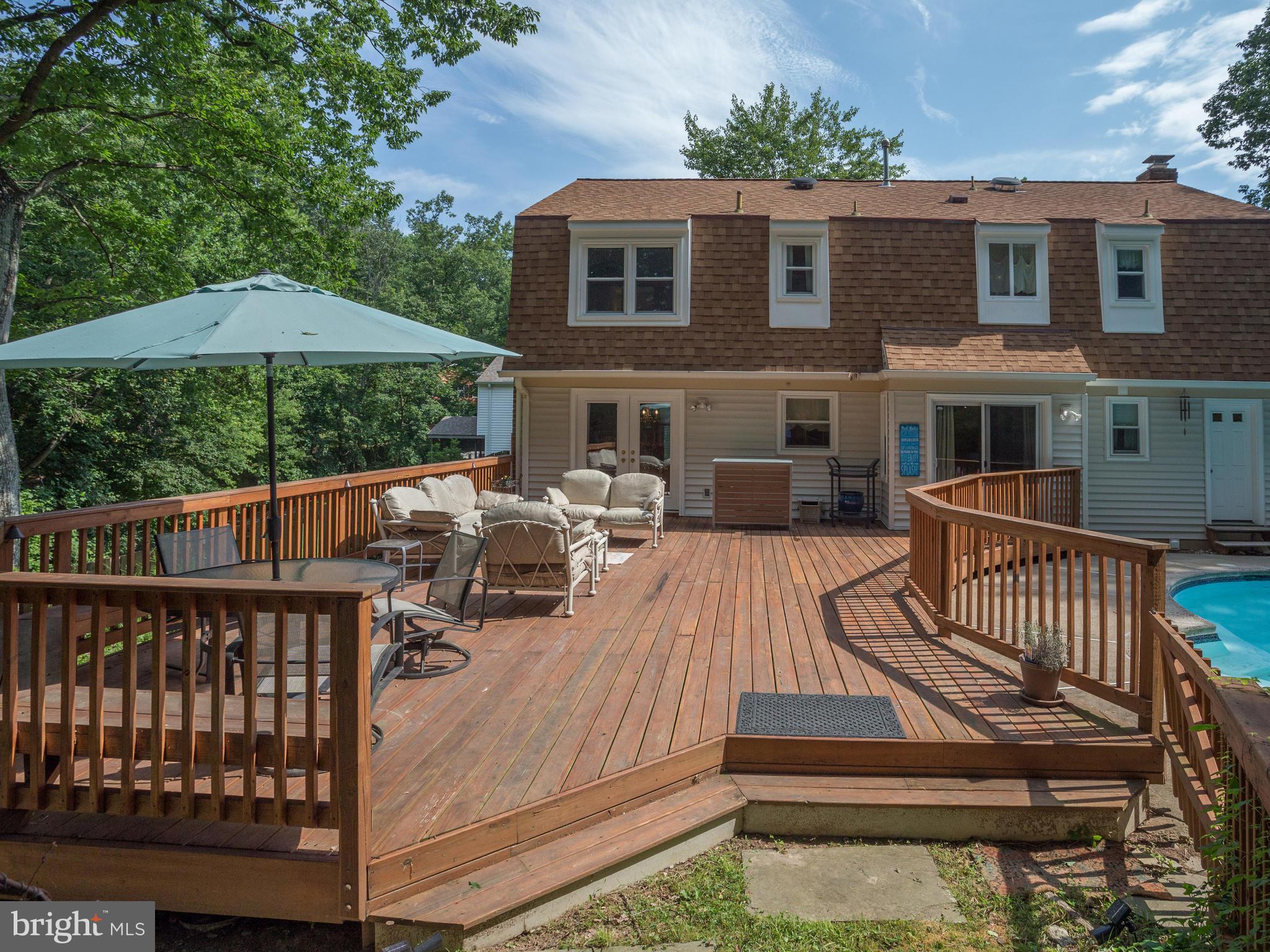 9031 Edgepark Road Vienna, VA 22182 - Photo 4 of 30 a view of a house with wooden deck and furniture