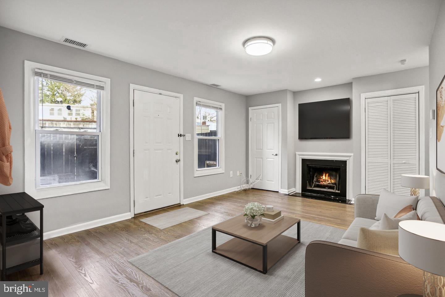 1507 Freedom Way Southeast, Unit 1 Washington, DC 20003 - Photo 3 of 15 a living room with furniture a fireplace and a flat screen tv