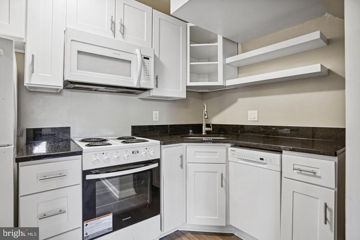 1507 Freedom Way Southeast, Unit 1 Washington, DC 20003 - Photo 4 of 15 a kitchen with white cabinets and white appliances