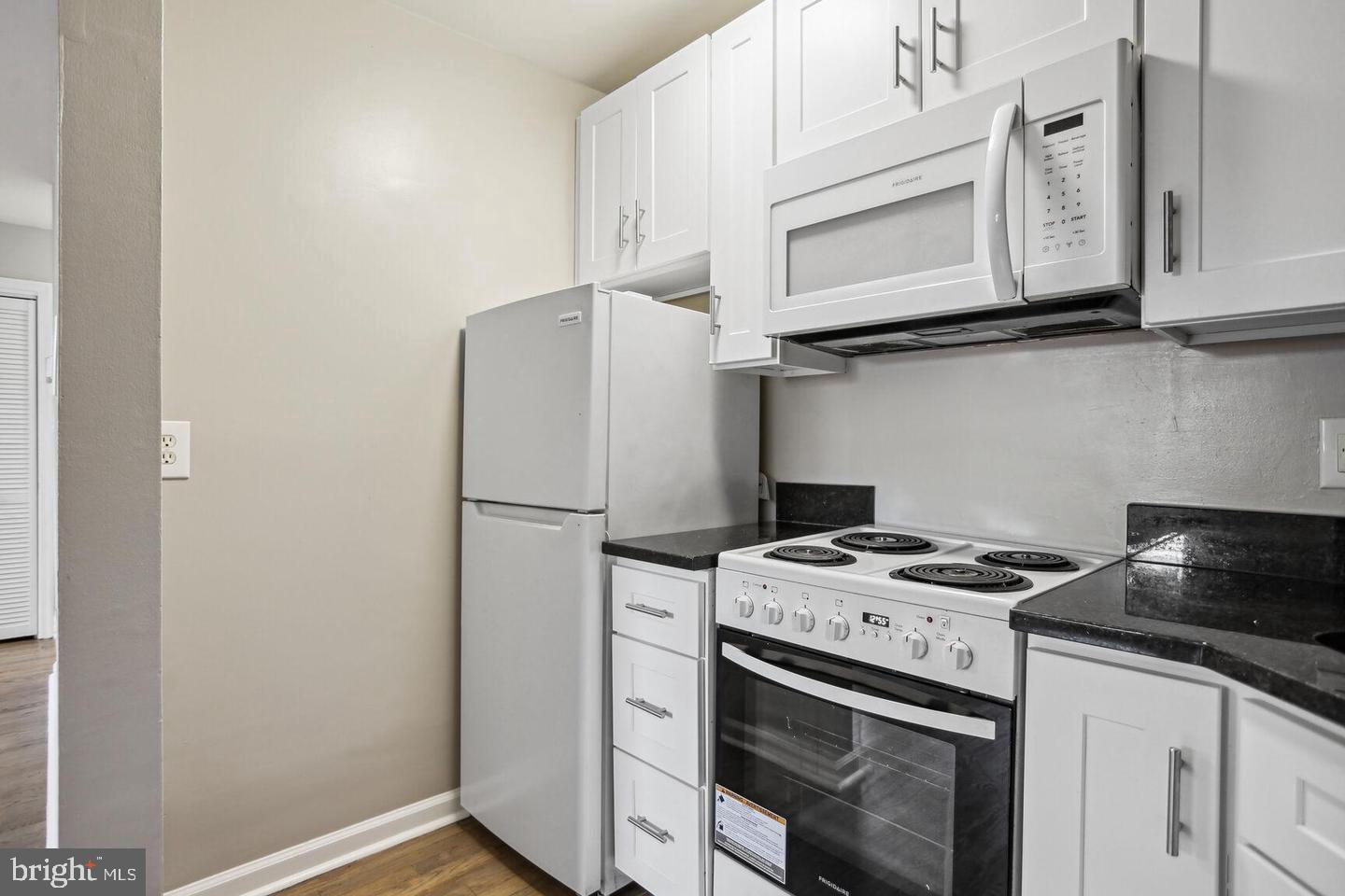 1507 Freedom Way Southeast, Unit 1 Washington, DC 20003 - Photo 6 of 15 a kitchen with stainless steel appliances granite countertop a stove a refrigerator and cabinets