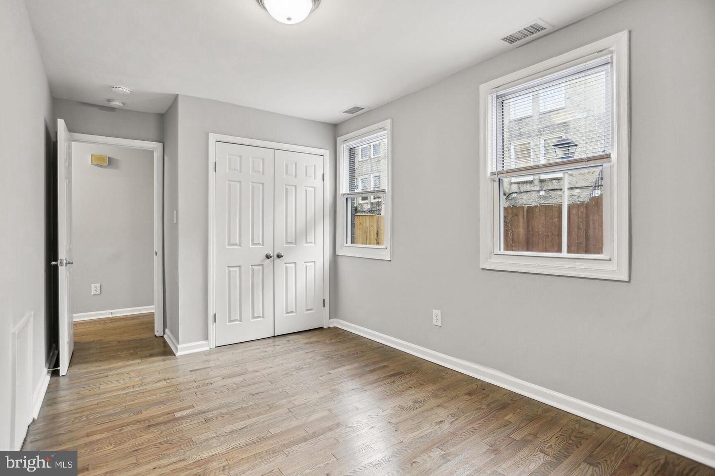 1507 Freedom Way Southeast, Unit 1 Washington, DC 20003 - Photo 9 of 15 a view of an empty room with wooden floor and windows