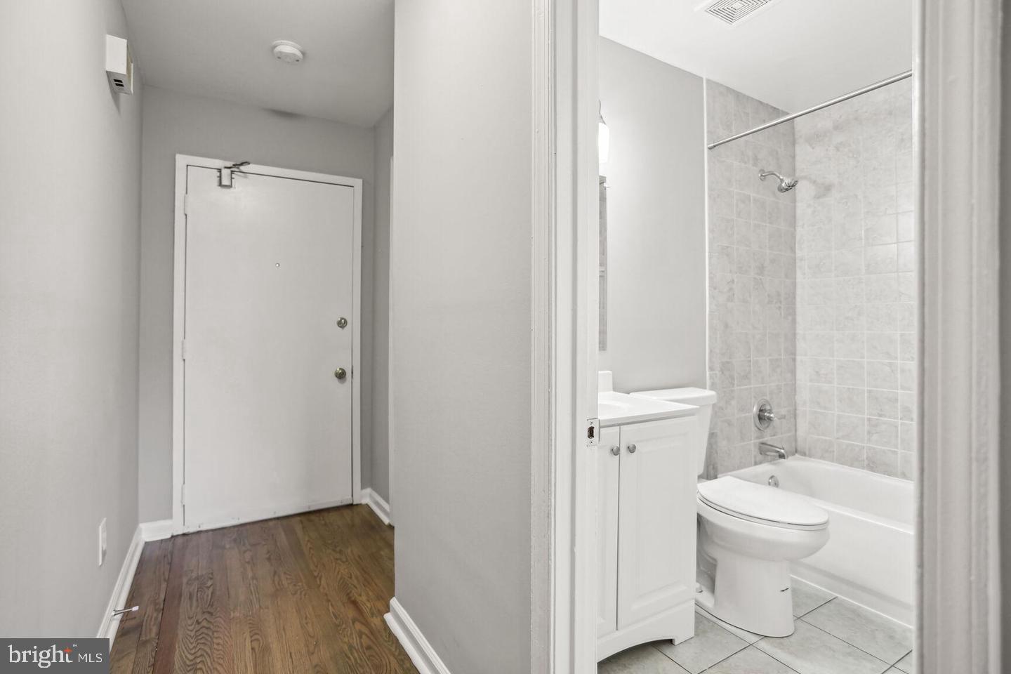 1507 Freedom Way Southeast, Unit 1 Washington, DC 20003 - Photo 10 of 15 a bathroom with a granite countertop sink a toilet and shower