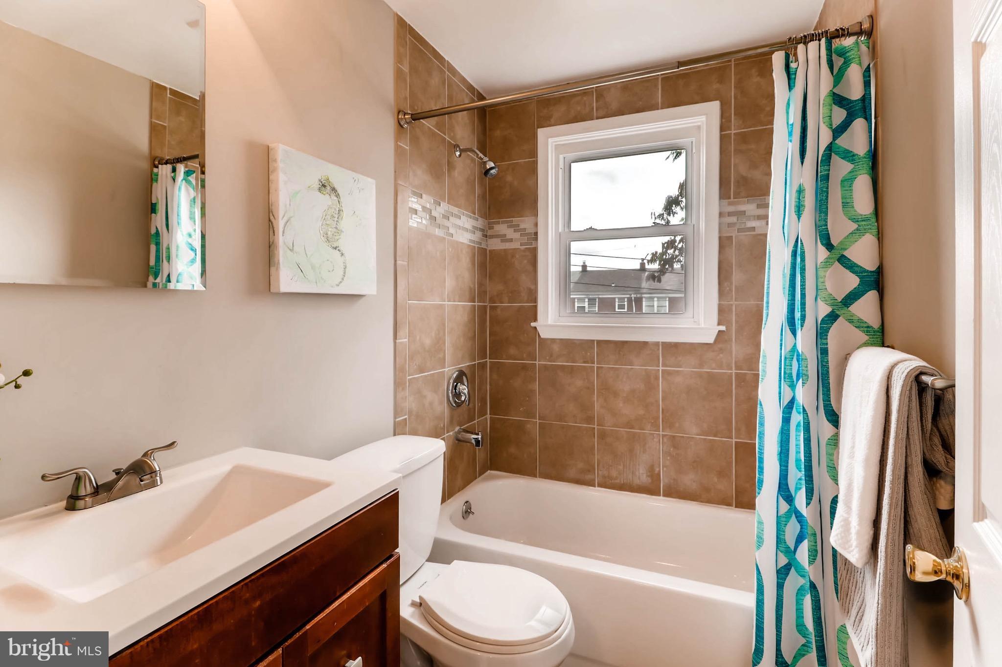 2107 Redthorn Road Baltimore, MD 21220 - Photo 8 of 14 a bathroom with a sink a toilet and a bathtub