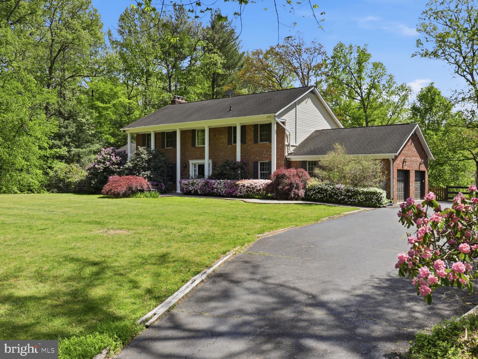 5605 Smoke Rise Lane Fairfax Station, VA 22039 - Photo 1 of 86 a front view of house with yard and green space