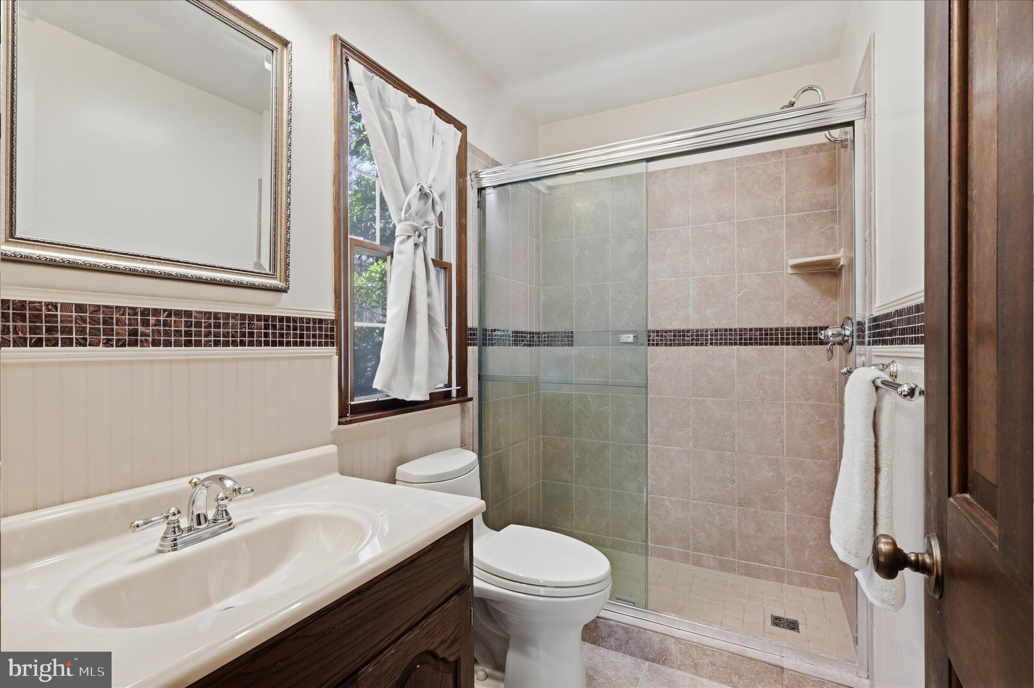 5605 Smoke Rise Lane Fairfax Station, VA 22039 - Photo 28 of 85 a bathroom with a sink toilet and shower