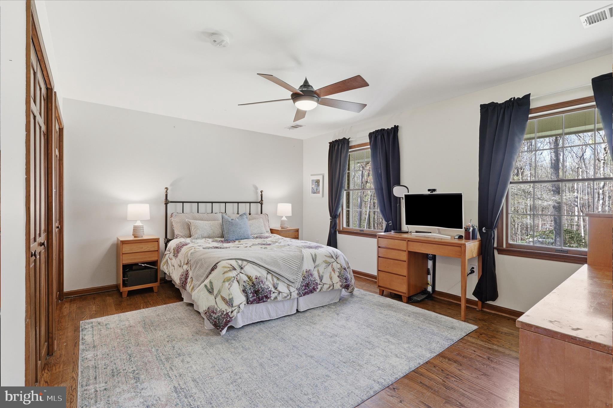 5605 Smoke Rise Lane Fairfax Station, VA 22039 - Photo 33 of 86 a bedroom with bed table and flat screen tv