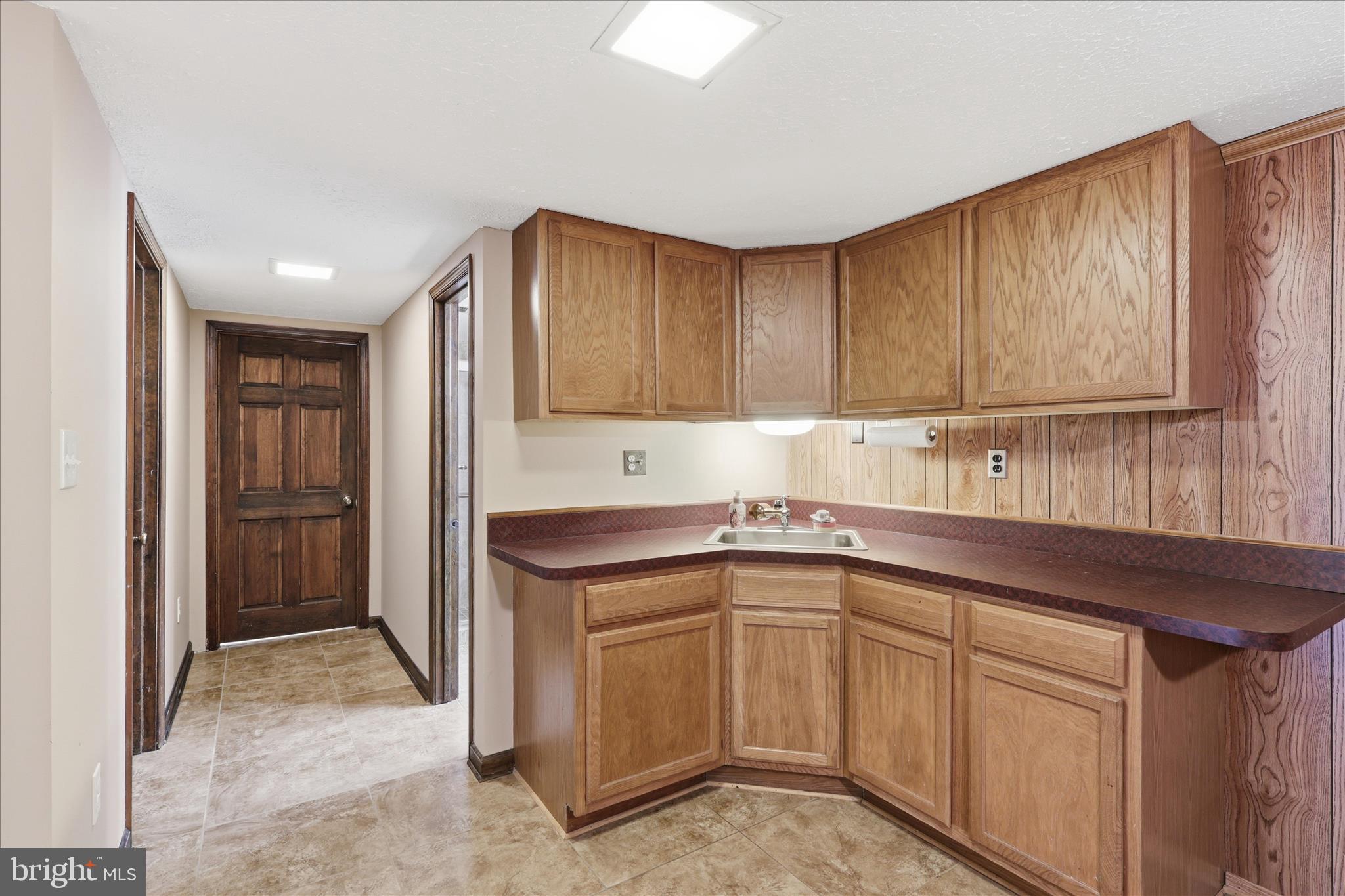 5605 Smoke Rise Lane Fairfax Station, VA 22039 - Photo 41 of 86 a kitchen with a sink cabinets and stainless steel appliances