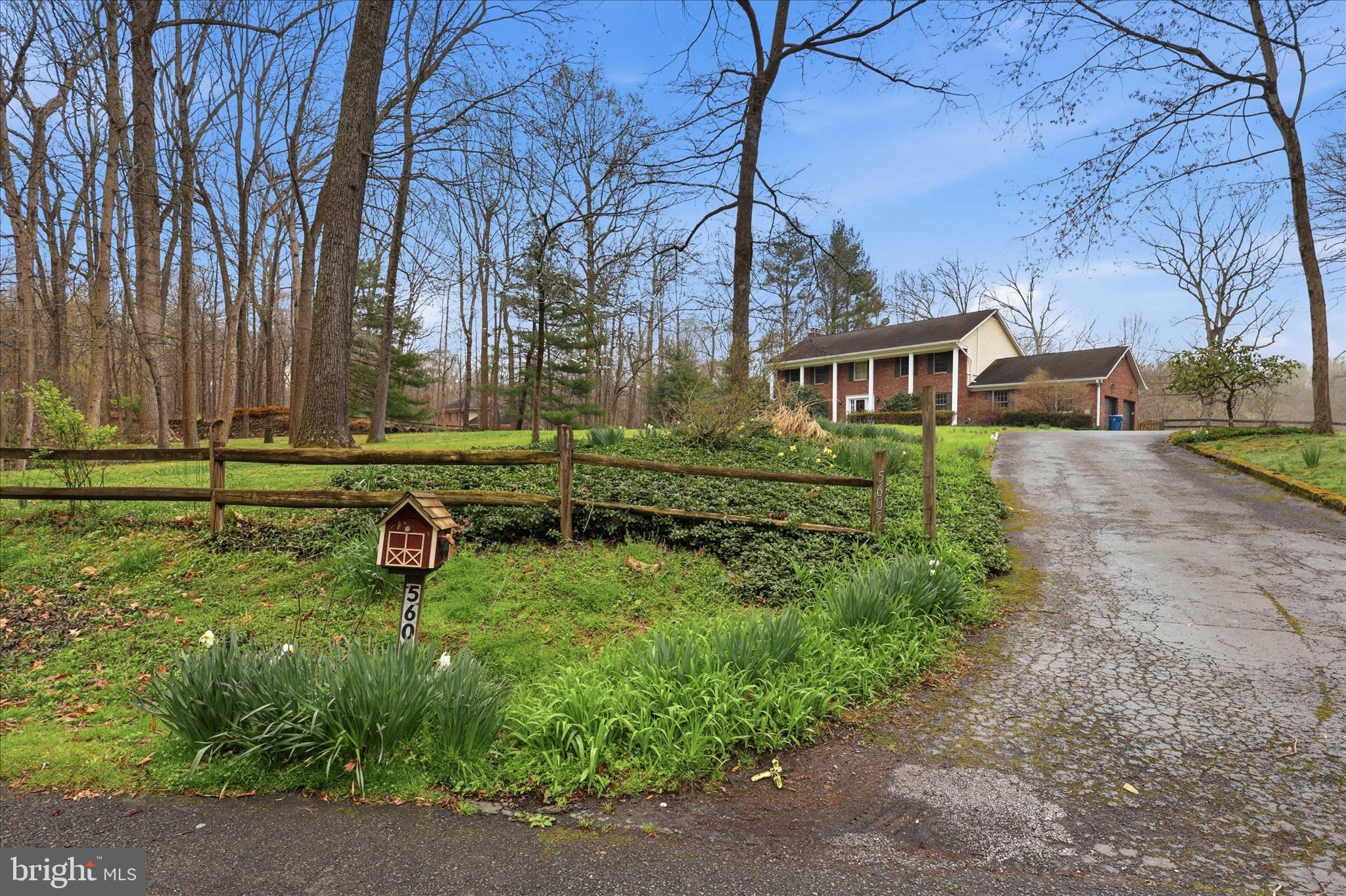 5605 Smoke Rise Lane Fairfax Station, VA 22039 - Photo 5 of 85 front view of a house with a yard and trees