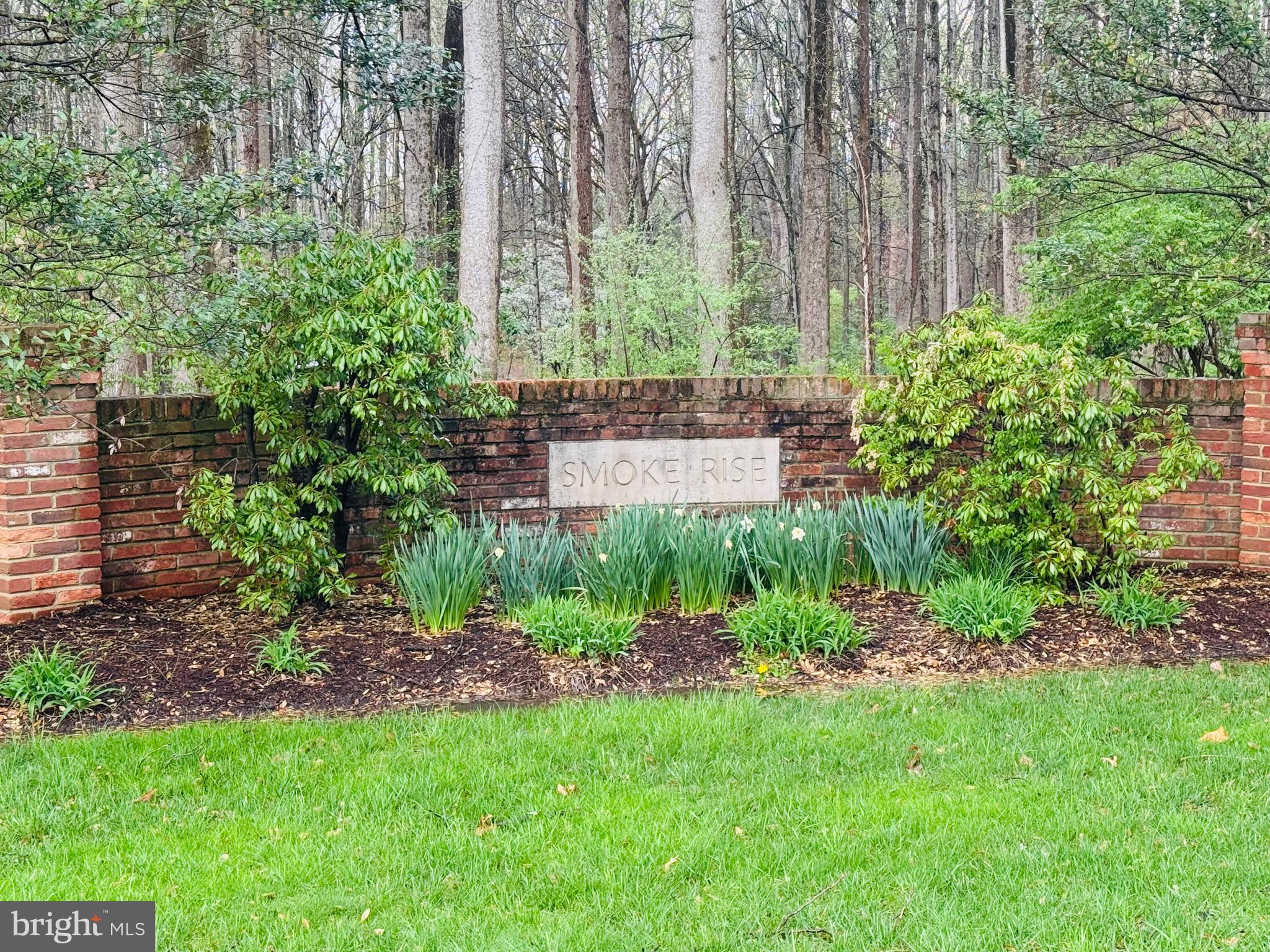 5605 Smoke Rise Lane Fairfax Station, VA 22039 - Photo 76 of 86 a view of a garden with a bench in a garden