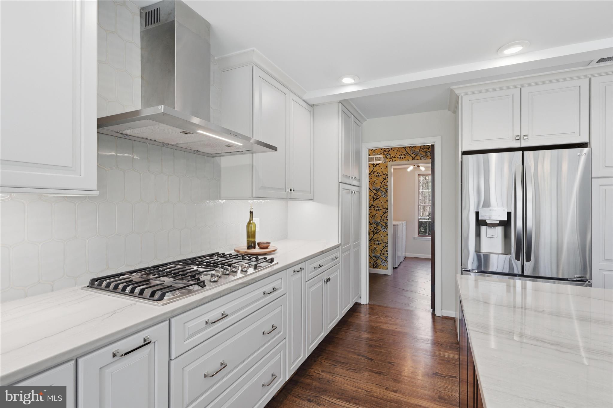 5605 Smoke Rise Lane Fairfax Station, VA 22039 - Photo 8 of 85 a kitchen with stainless steel appliances a stove a refrigerator and cabinets