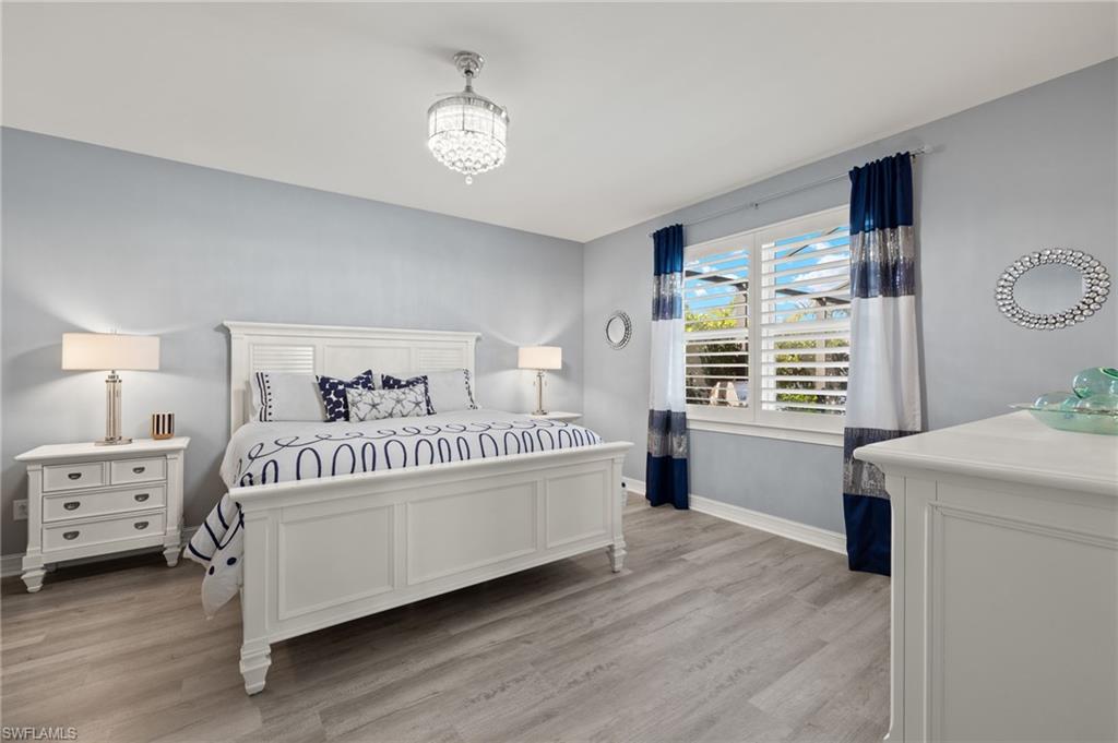 14651 Topsail Drive Naples, FL 34114 - Photo 11 of 37 a bedroom with a bed and a window
