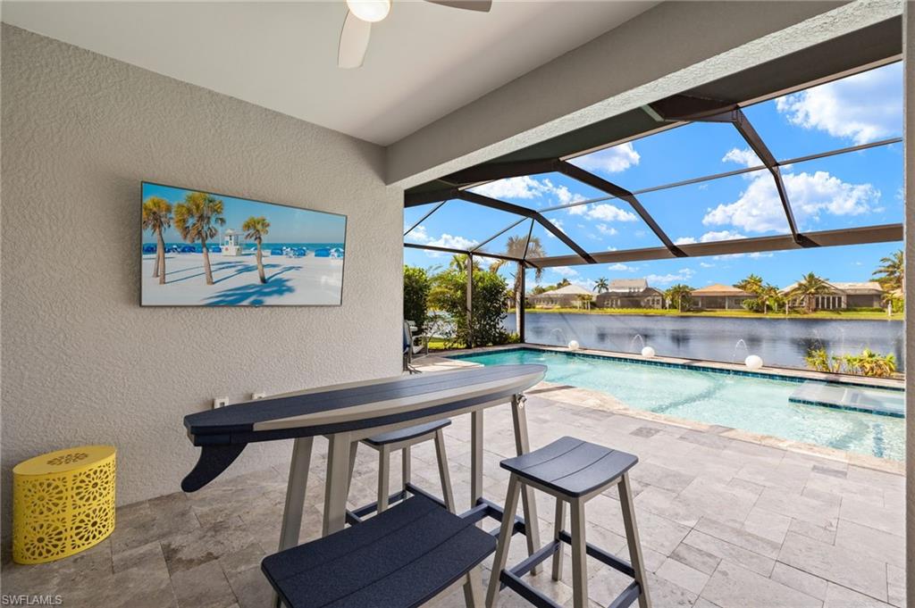 14651 Topsail Drive Naples, FL 34114 - Photo 21 of 37 a room with furniture and a floor to ceiling window