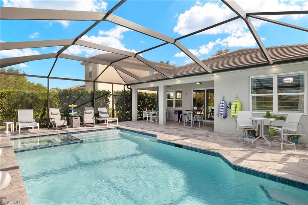 14651 Topsail Drive Naples, FL 34114 - Photo 25 of 37 a view of a backyard with a swimming pool